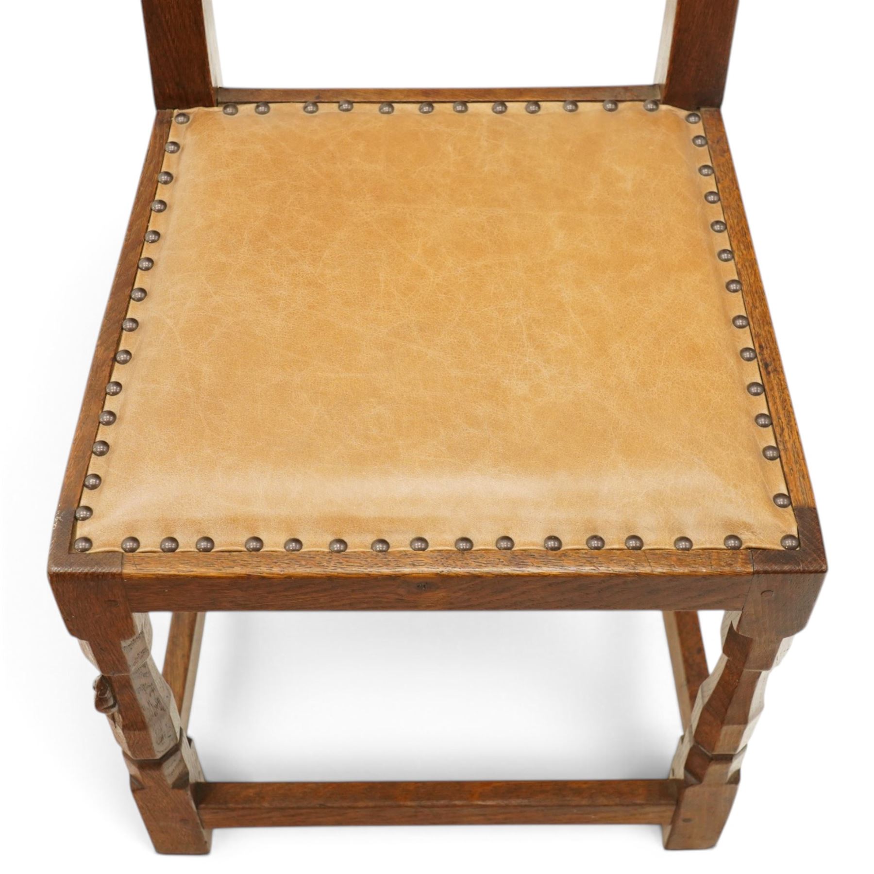 Mouseman side chair- panelled adzed back over tan leather upholstered seat with studwork, on octagonal front supports united by stretchers, each with signature carved mouse, by the workshop of Robert Thompson, Kilburn