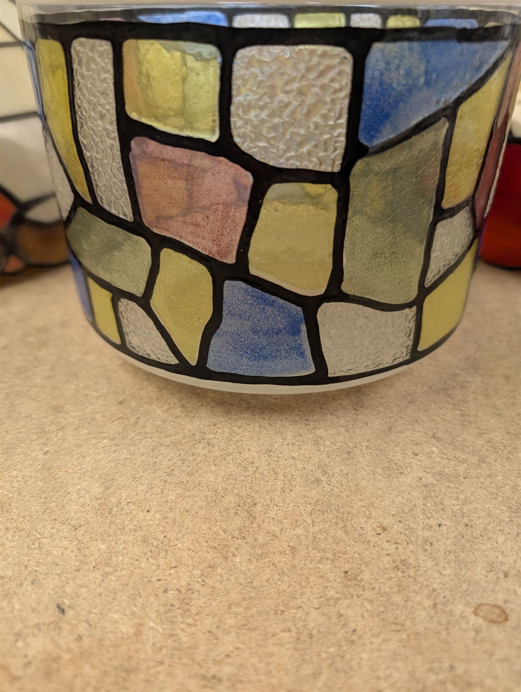 Two Tiffany style domed lampshades, together with a circular glass shade with stained glass decoration, largest H15cm, D30cm