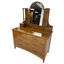 Edwardian mahogany dressing chest, raised arched mirror back with bevelled plate flanked by uprights carved with Art Nouveau tulip motifs over trinket drawers, base fitted with two short over two long drawers