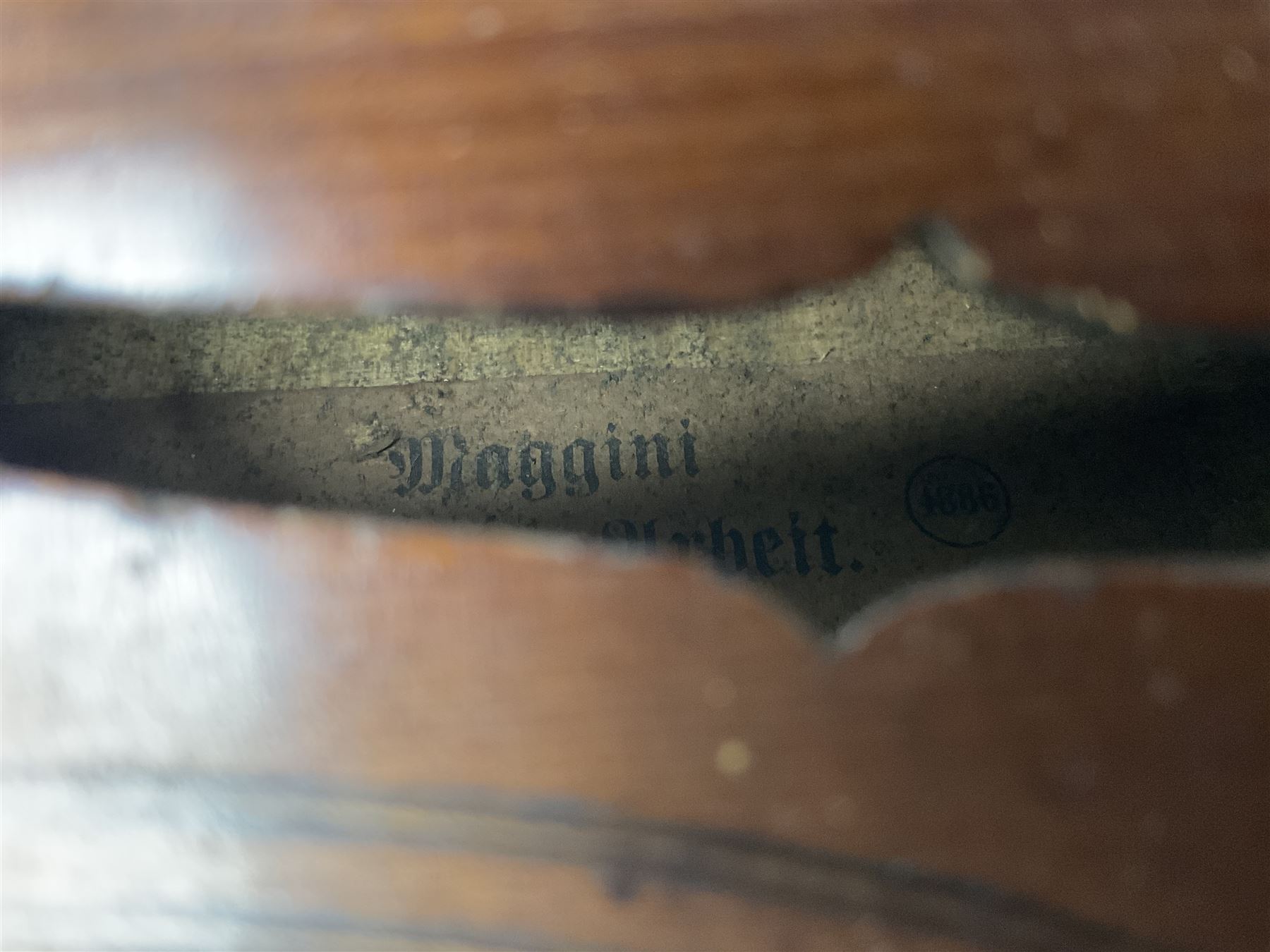 German copy of a Maggini violin c1900 with 35.5cm two-piece maple back and ribs and spruce top, bears label 'Maggini Deutsche Arbeit 1866' L59cm; in carrying case with bow