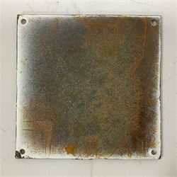 Cast iron 'In God we Trust' sign with black writing on a white ground, H15cm