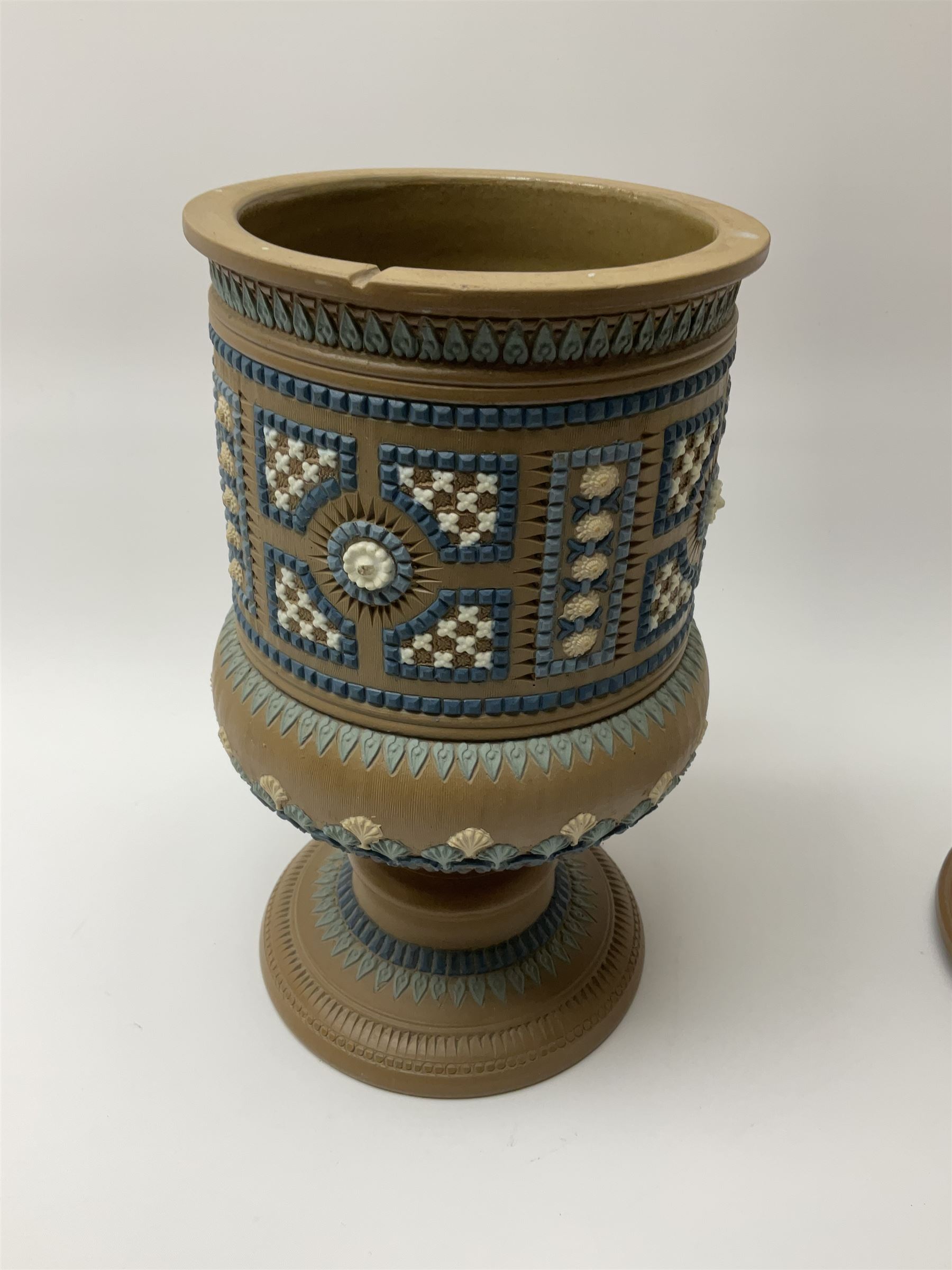 A late 19th century Doulton Lambeth stoneware water filter with original spigot, decorated with relief moulded foliate bands, with impressed marks and monogrammed for Laura Gooderham beneath, H34cm. 