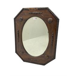 Early 20th century oak framed wall mirror, chamfered corners with beading border, oval bevelled plate