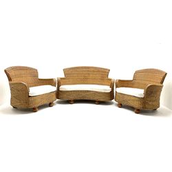 Rattan conservatory suite, to include a two seat sofa (W135cm) and two matching armchairs (W94cm), upholstered with matching seat covers, together with glass topped rattan coffee table (W96cm)