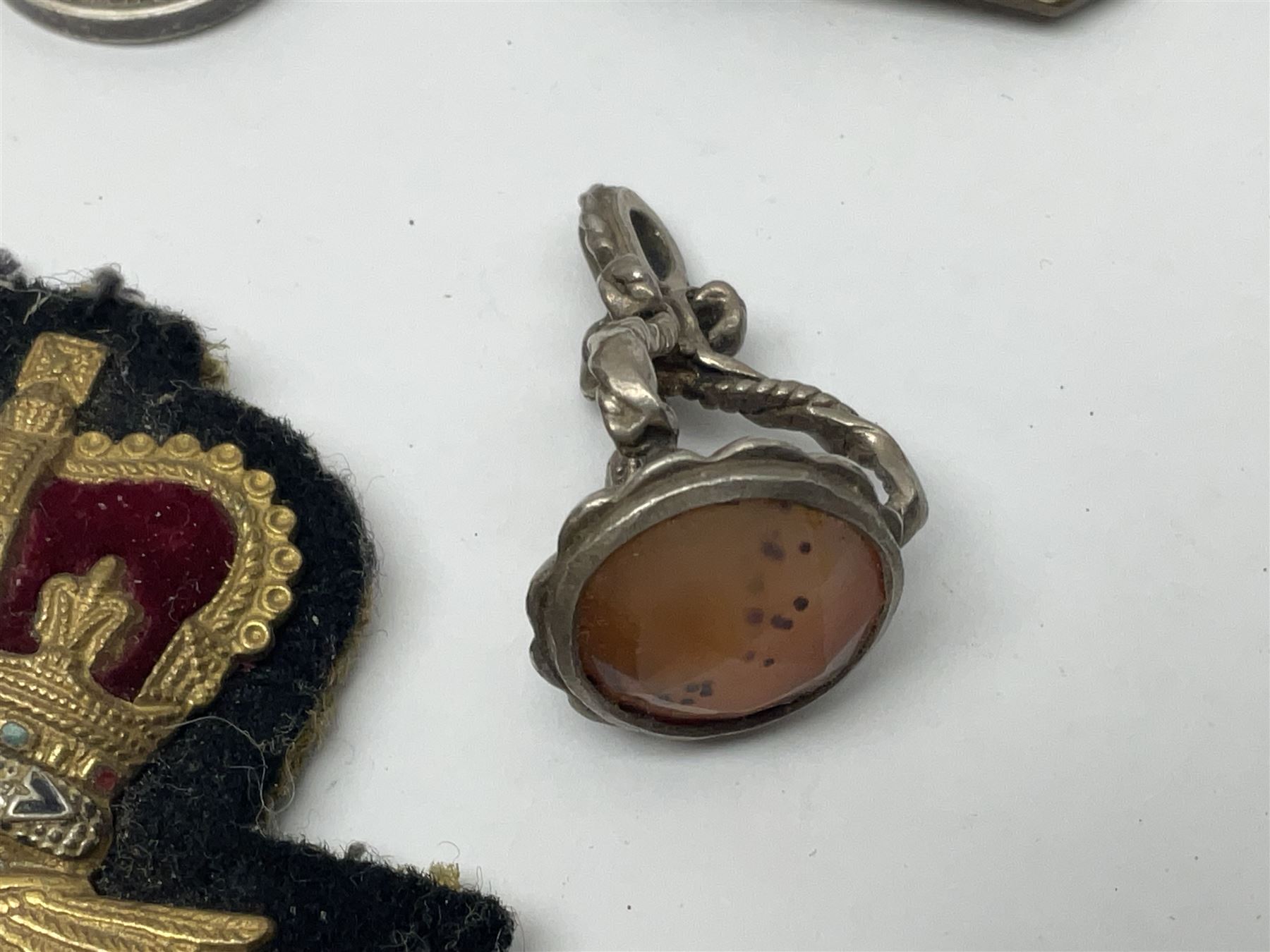 Collectables, to include enamelled Gothic Florin, Hull Rudston and Preston 1811 one shilling six pence token, silver gilt Hull Airedale Terrier Club fob, silver and tortoiseshell badge inscribed East Yorkshire beneath Yorkshire Rose, polychrome enamel buckle, mother of pearl badge carved with rose and tiger and inscribed York & Lancaster, etc.