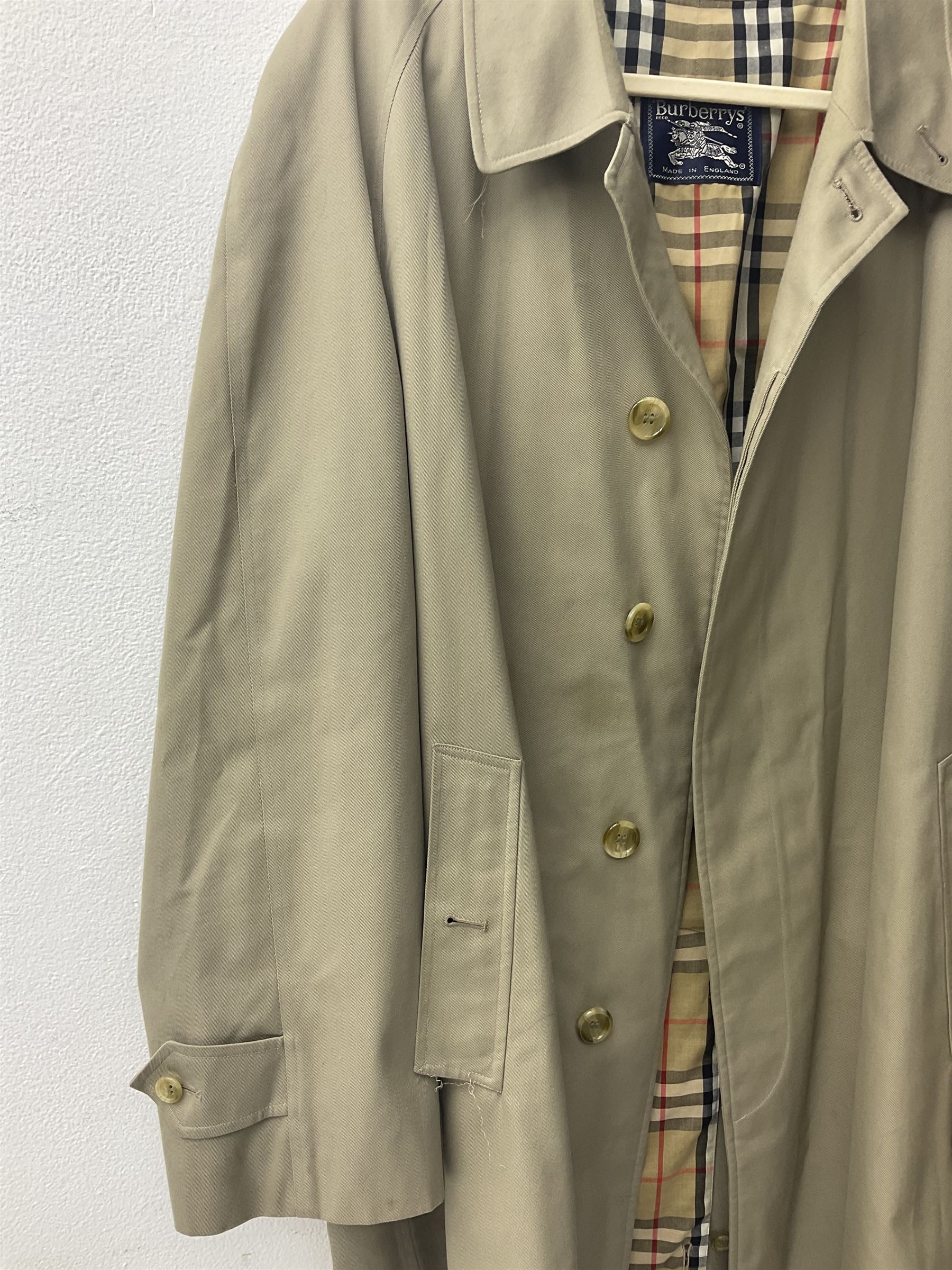 Ladies Burberry double breasted trench coat, with belt and detachable woollen gilet, in traditional cream colour with Burberry check lining, together with a gentlemans Burberry single breasted trench coat, both L112cm