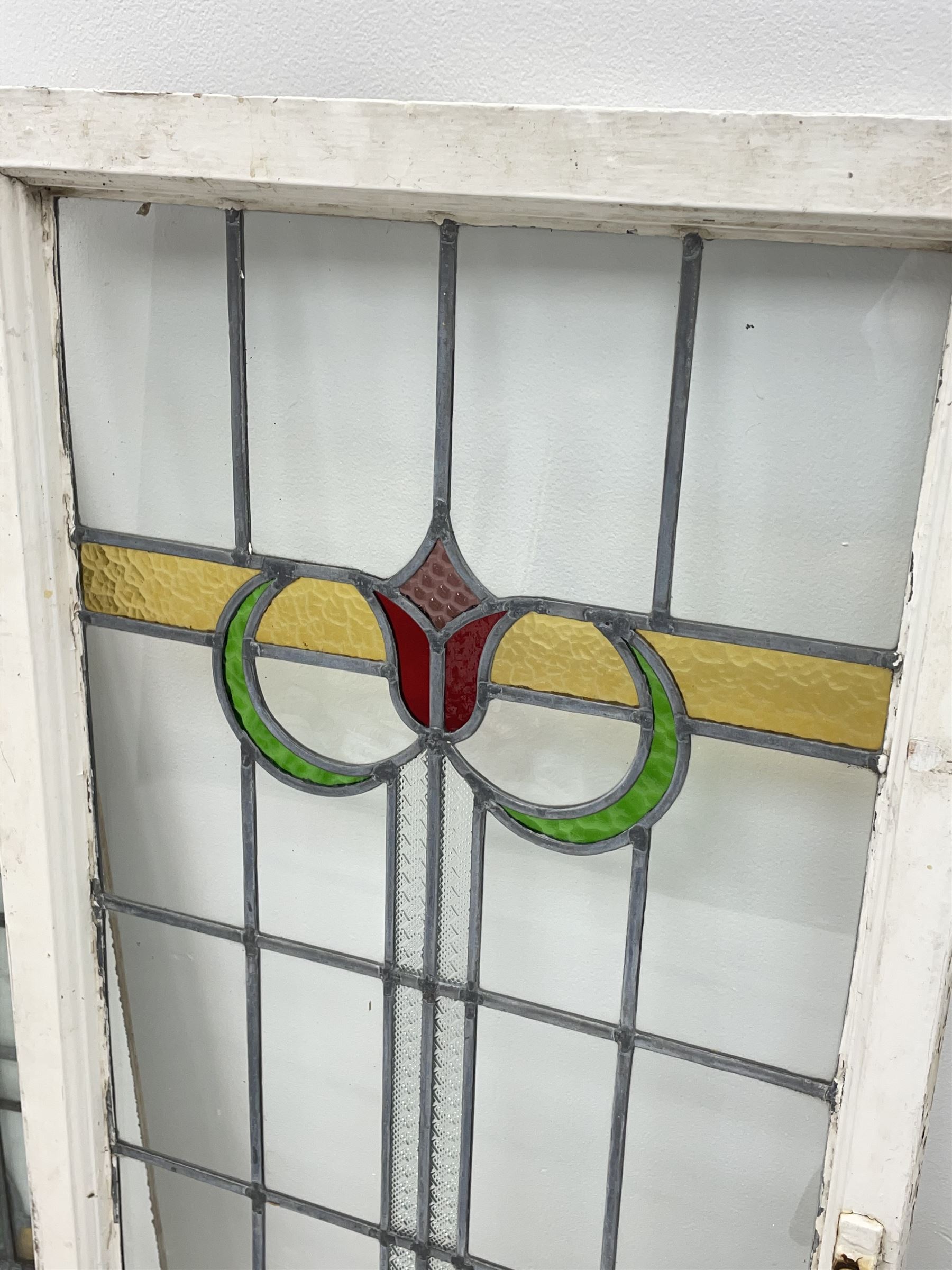 Collection of stained and leaded glass windows and panes, stylised floral design, various sizes, the largest window measuring 55cm x 112cm (including wooden frame)