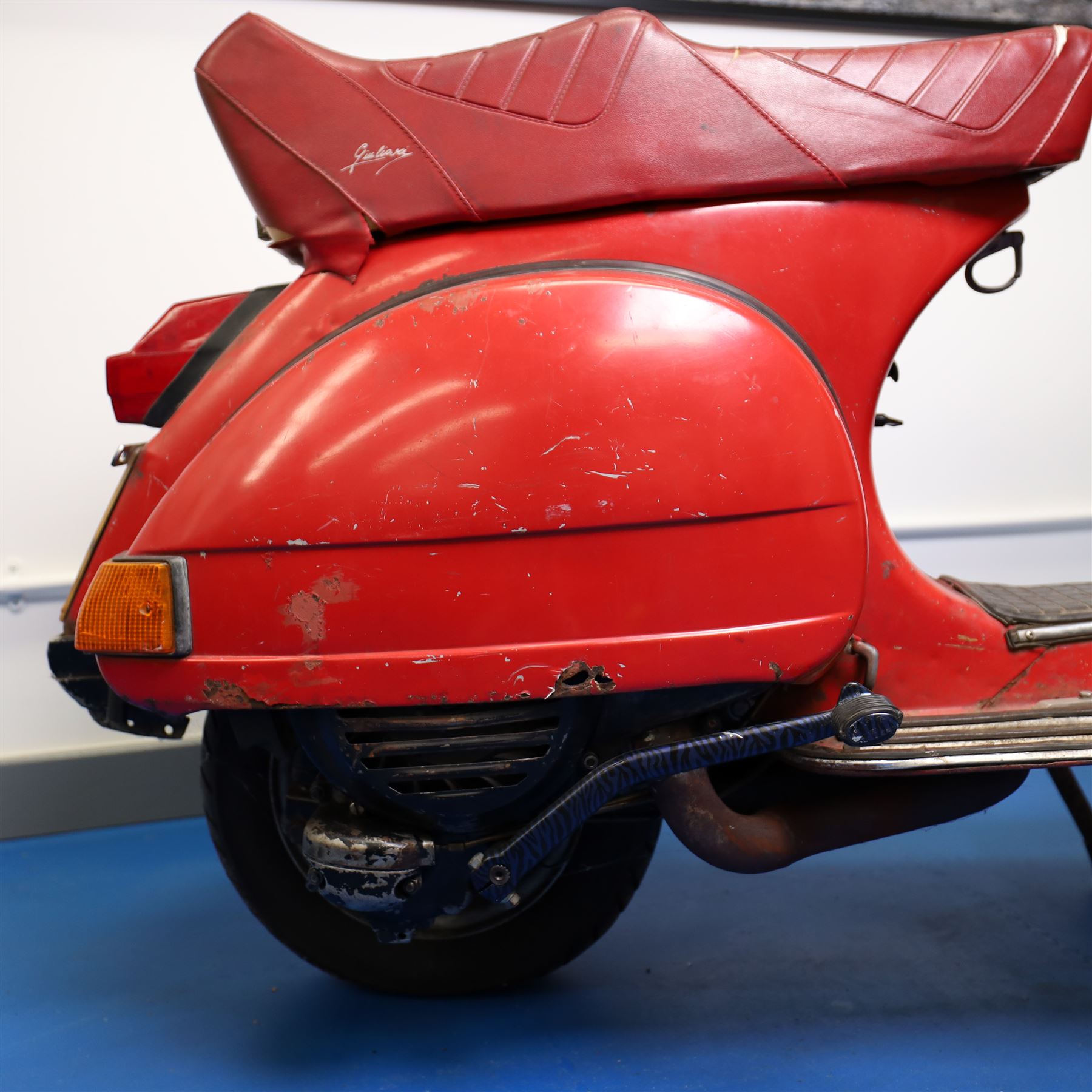 1979 Piaggio Vespa 200 Scooter

• Registration: TVY 25T
• Date of first registration: 1979
• Engine: 197cc petrol
• Odometer reading: 9,960 miles
• Colour: Red
• V5C: Present
• Keys: One

A 1979 Piaggio Vespa 200, registered TVY 25T and finished in red. Powered by a 197cc petrol engine, the scooter displays 9,960 miles on its Veglia Borletti odometer, although this mileage has not been independently verified.

The Vespa 200 is one of the larger-capacity models in the classic Vespa range, combining the marque’s distinctive pressed-steel construction with a practical 197cc engine and traditional handlebar gear change.

This example is presented in largely original and unrestored condition, retaining its period bodywork, Piaggio and Vespa badging, original-style controls and Yankee-branded dual seat.

The scooter shows extensive age-related wear throughout, including paint loss, scratches, surface corrosion and deterioration to the bodywork, including a perforation to the inner legshield.

This vehicle forms part of the Estate of the Late John Sills and is offered for sale by the Executors, confirming a genuine reason for sale.