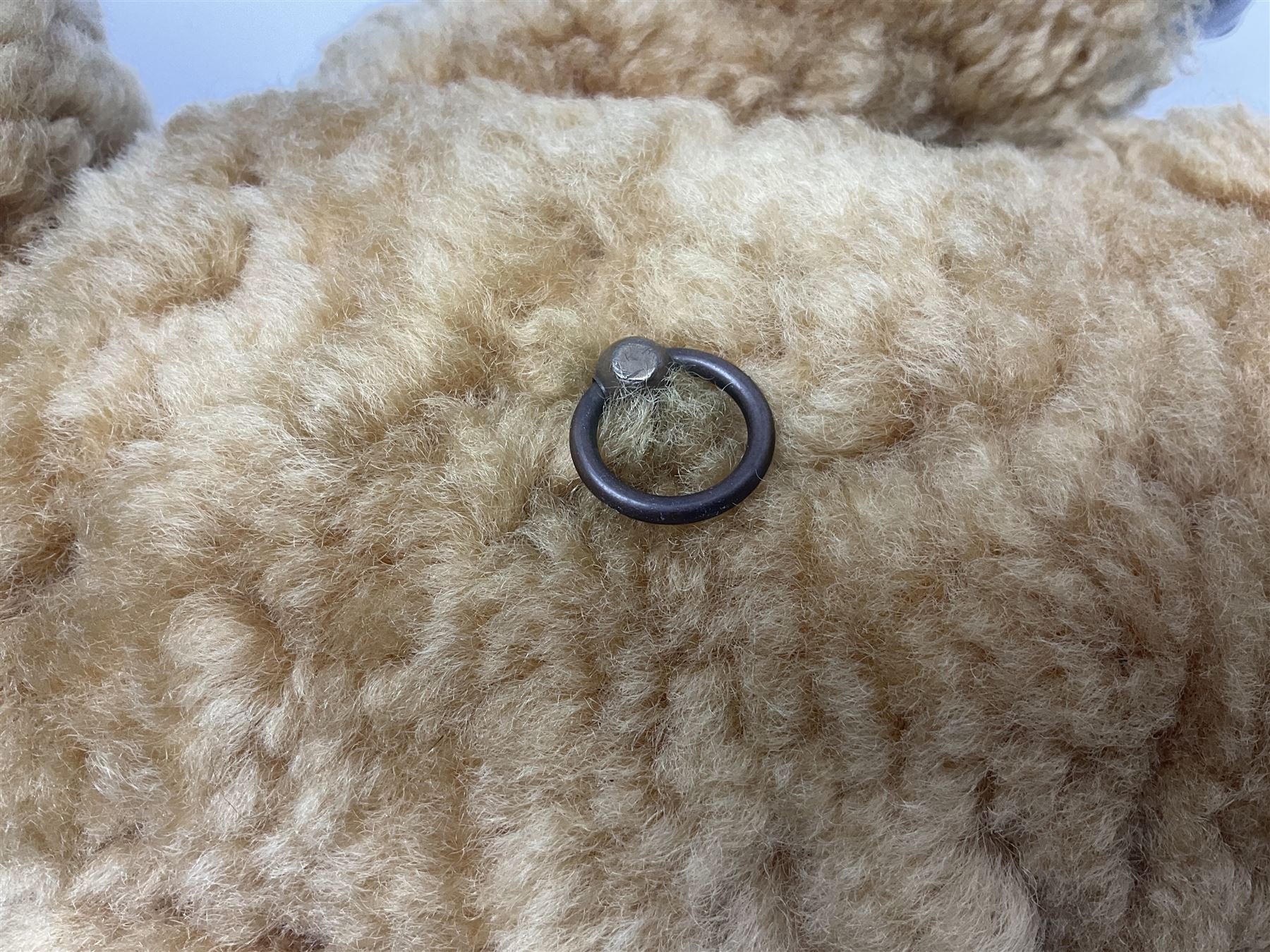 1950s sheepskin plush covered teddy bear with musical movement, the revolving head with applied eyes, leather nose and stitched mouth, jointed limbs with leather pads H50cm