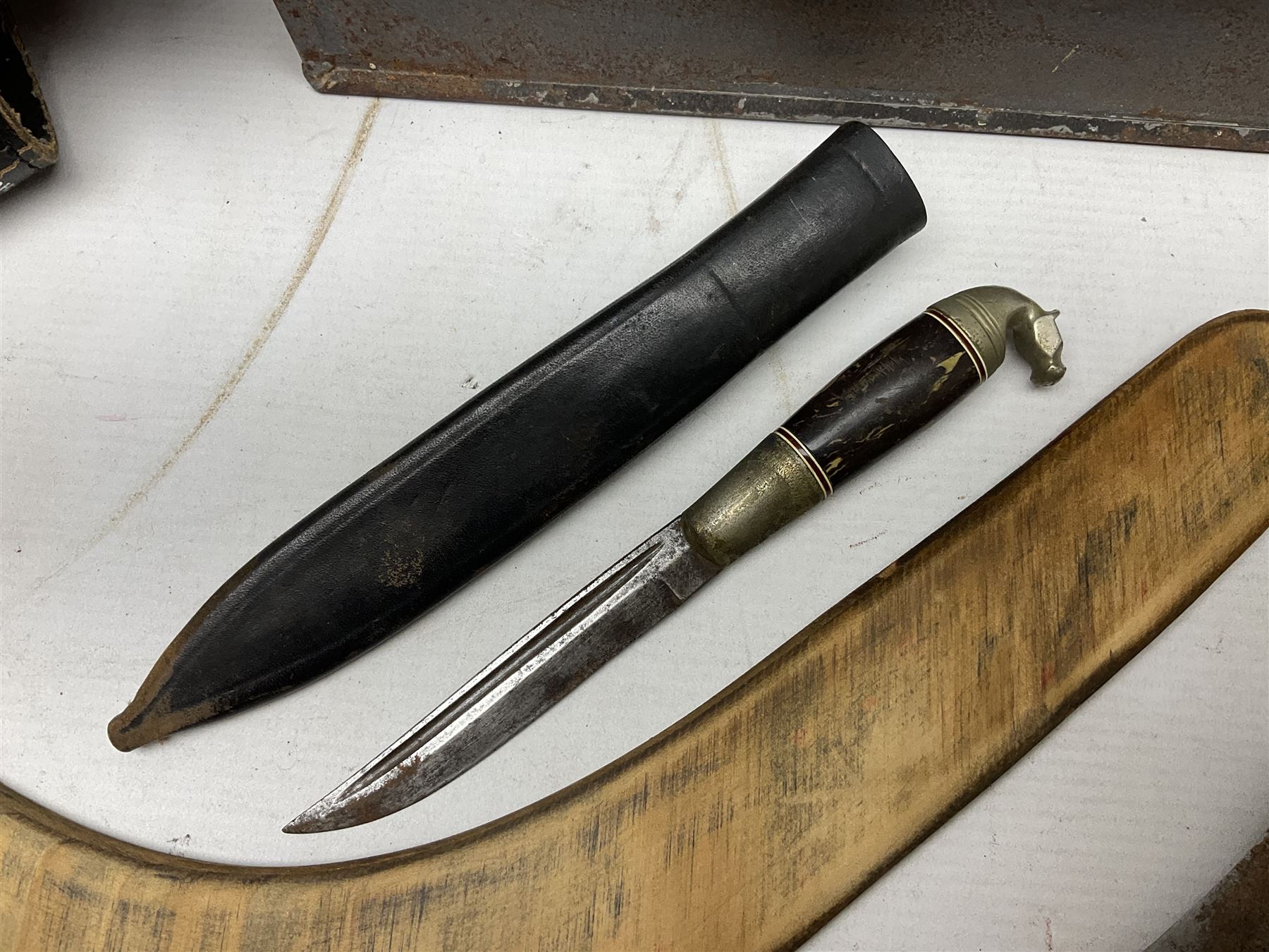 Assorted militaria including ten leather or canvas cartridge and other belts, maroon beret with 17th Lancers cap badge, modern bullet mould, leather and brass shot flask, two knives, shell cases, boomerang etc; in tin deed box