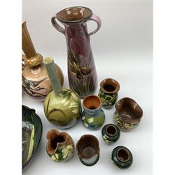 Collection of Devon pottery all having floral slip decoration and include Aller Vale, Watcombe, possibly some Longpark, and other unmarked pieces, tallest H25cm together with a pair of T. Forester jugs hand-painted with cranes and two further Devon pottery pieces, both hand-plated with birds 