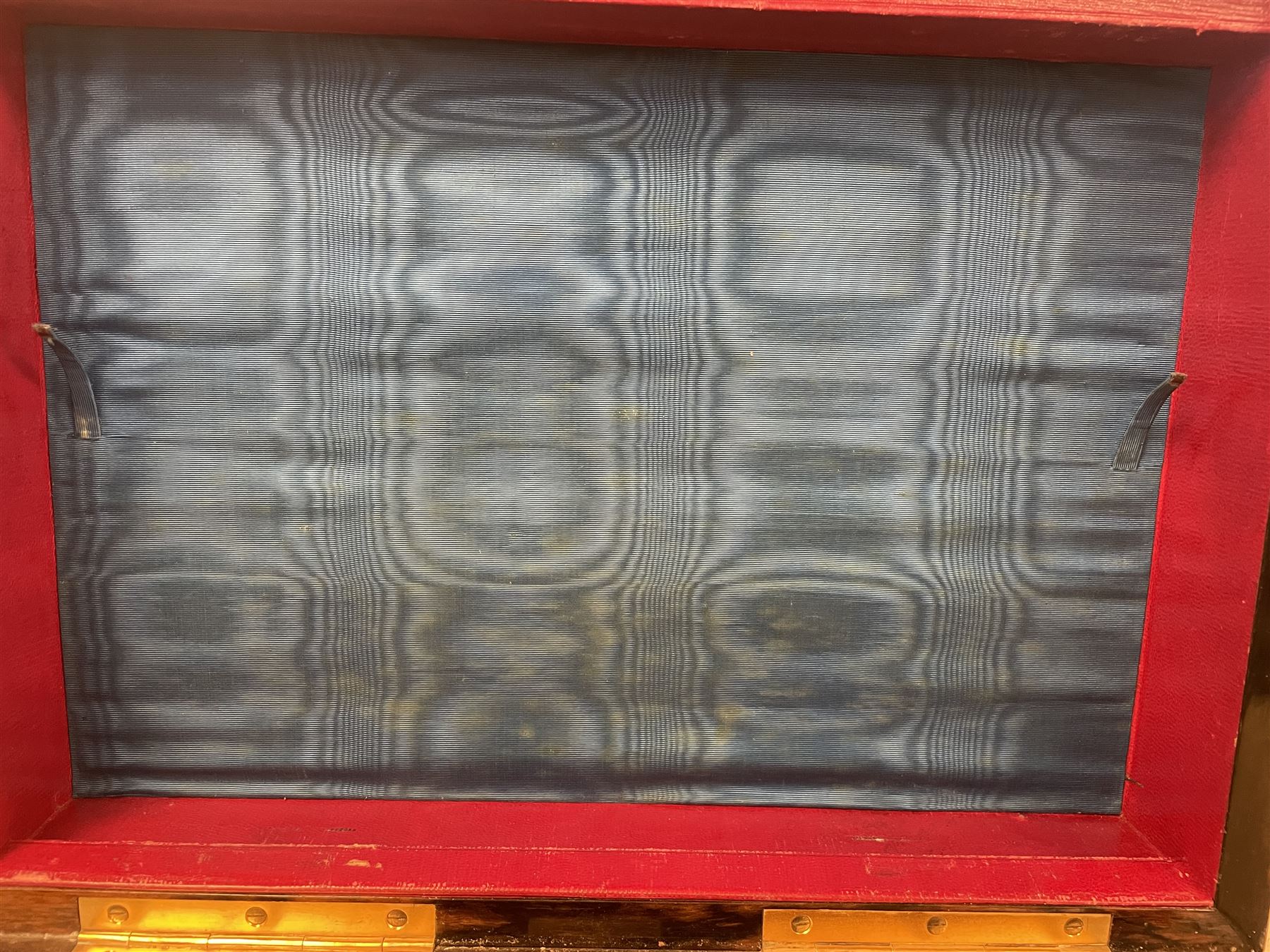 19th century walnut and brass bound games compendium box, painted to enhance the grain, of rectangular form, the hinged opening cover with rounded sides, central brass cartouche with engraved lion crest, and brass riveted straps, opening to reveal a red leather and blue silk lined compartmented interior, with fold-down games board, and lift-out tray containing playing cards, ebony turned dice towers, white and red stained bone draughts, and chess pieces, ivory dice, and ivory and ebony whist markers, and brass bezique board, cribbage board and markers, H15cm W32cm D24cm
This lot has been registered for sale under Section 10 of the APHA Ivory Act