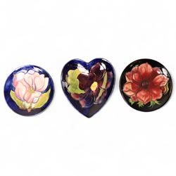 Three Moorcroft pin dishes, comprising heart shaped Clematis pattern example and two circu...