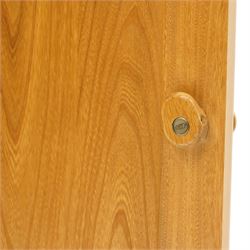 Ercol - elm corner display cabinet, Model 3856. Glazed upper section with glass door enclosing two glass shelves and interior light, above panel cupboard door, with rounded uprights and circular turned handles, on plinth base