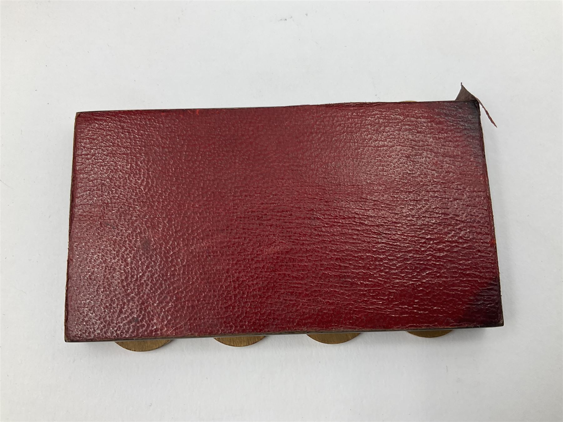 Edwardian silver mounted playing card case, hallmarked William Harrison Walter, Birmingham 1903, the sides each with a period playing card set behind a bevelled glass panel, the hinged cover with later engraving 'Presented to Norman T Crombie Esq by the officers & men of the 31st WR Detachment for services rendered 1917-1918', with red leather lined interior, the three compartments upon a sprung base and containing two later wooden Whist markers, case H12.5cm