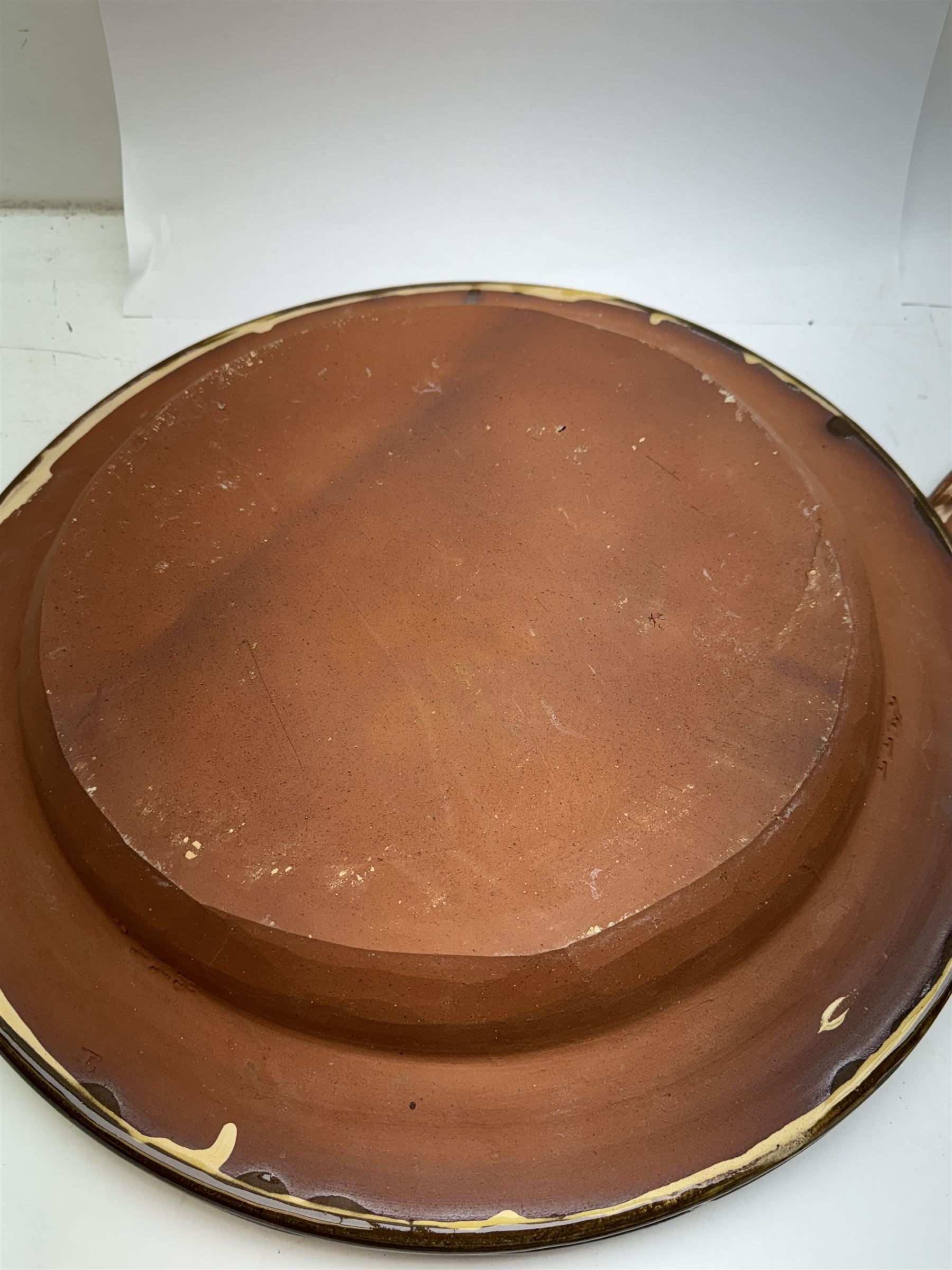 John Hudson: Large slipware charger in the style of Thomas Toft by John Hudson of Mirfield Pottery, decorated with the lion supporter taken by Toft from the Royal Arms, incised marks verso, D 44cm.
