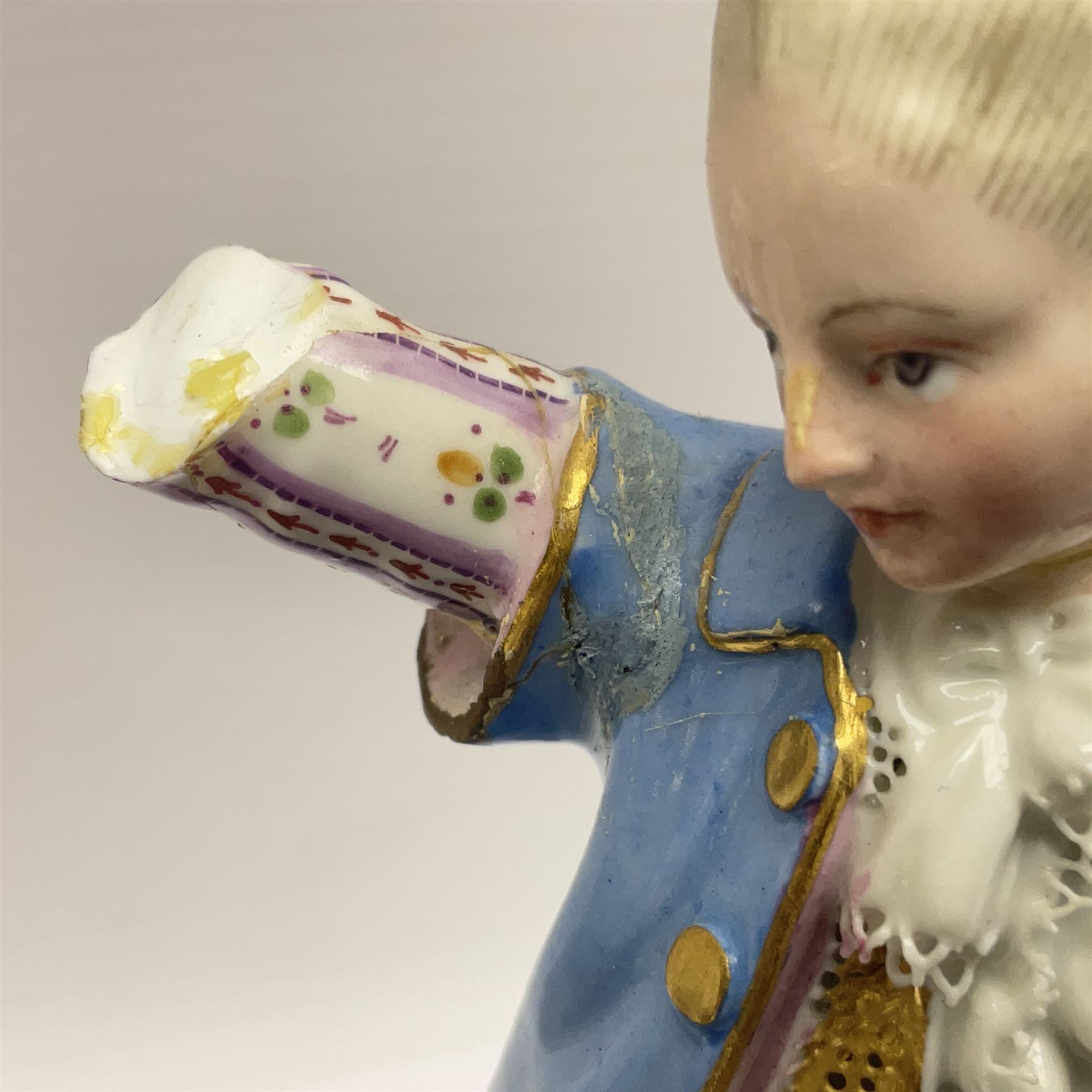 Pair of late 19th/early 20th Century Meissen figures, modelled as flower sellers, after the original by Michel Victor Acier, she holding basket of flowers, he holding flowers in his hat, each with underglaze cross swords mark beneath, tallest H16.5cm