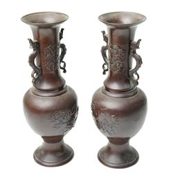 Pair of Japanese bronze vases, with twin handles in the form of dragons, decorated with flowers and traditional motifs to the neck and body, H31cm (2)