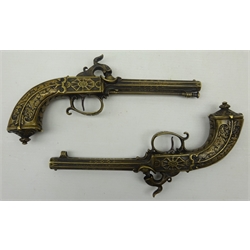  Pair of early 20th century French cast brass percussion pistols 12cm barrels engraved 'Pery et Patural' and 'Brevetes G. du G.' 22cm overall (lacking one ramrod)  