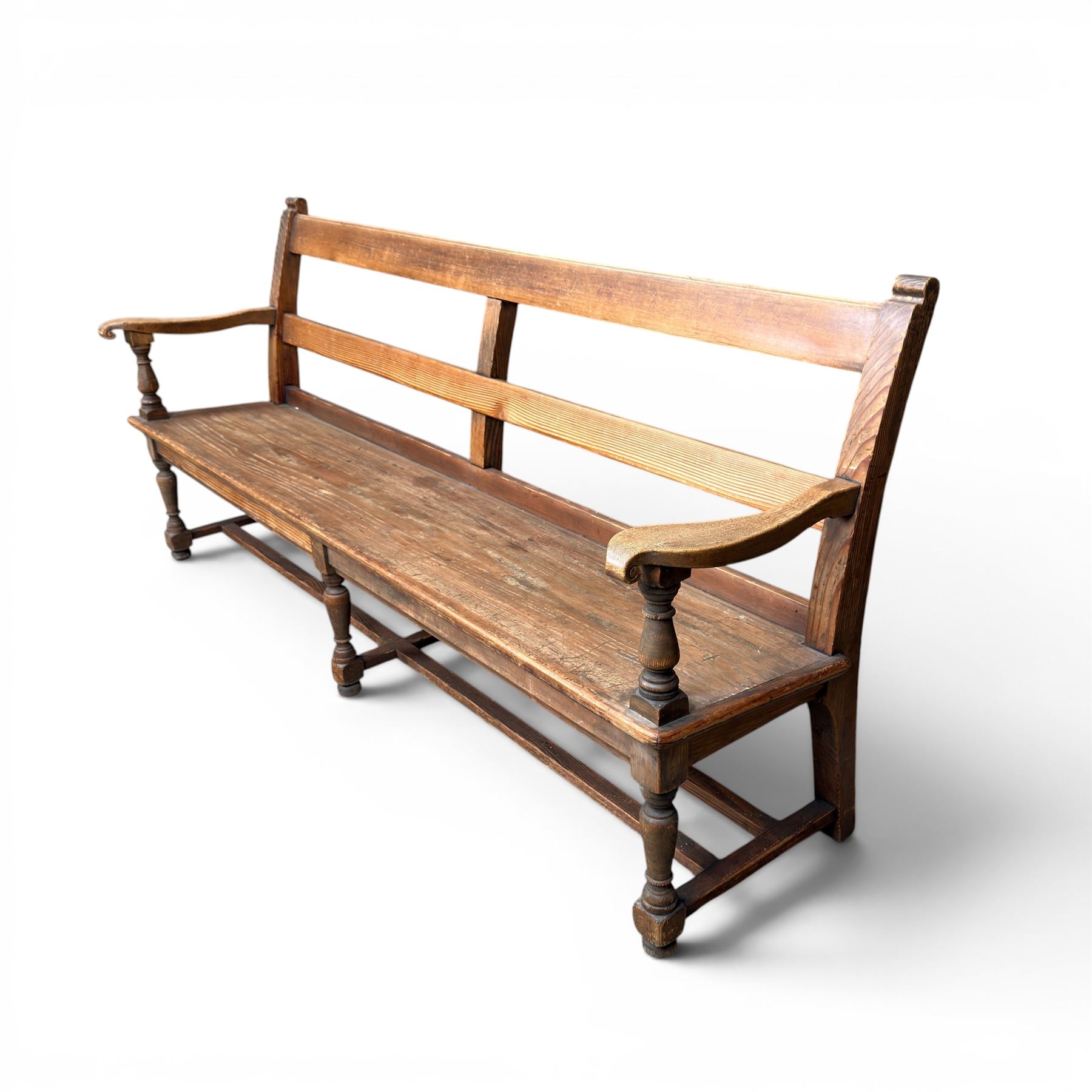Early 20th century pine and oak bench seat, stained pine rail back frame with shaped oak arms