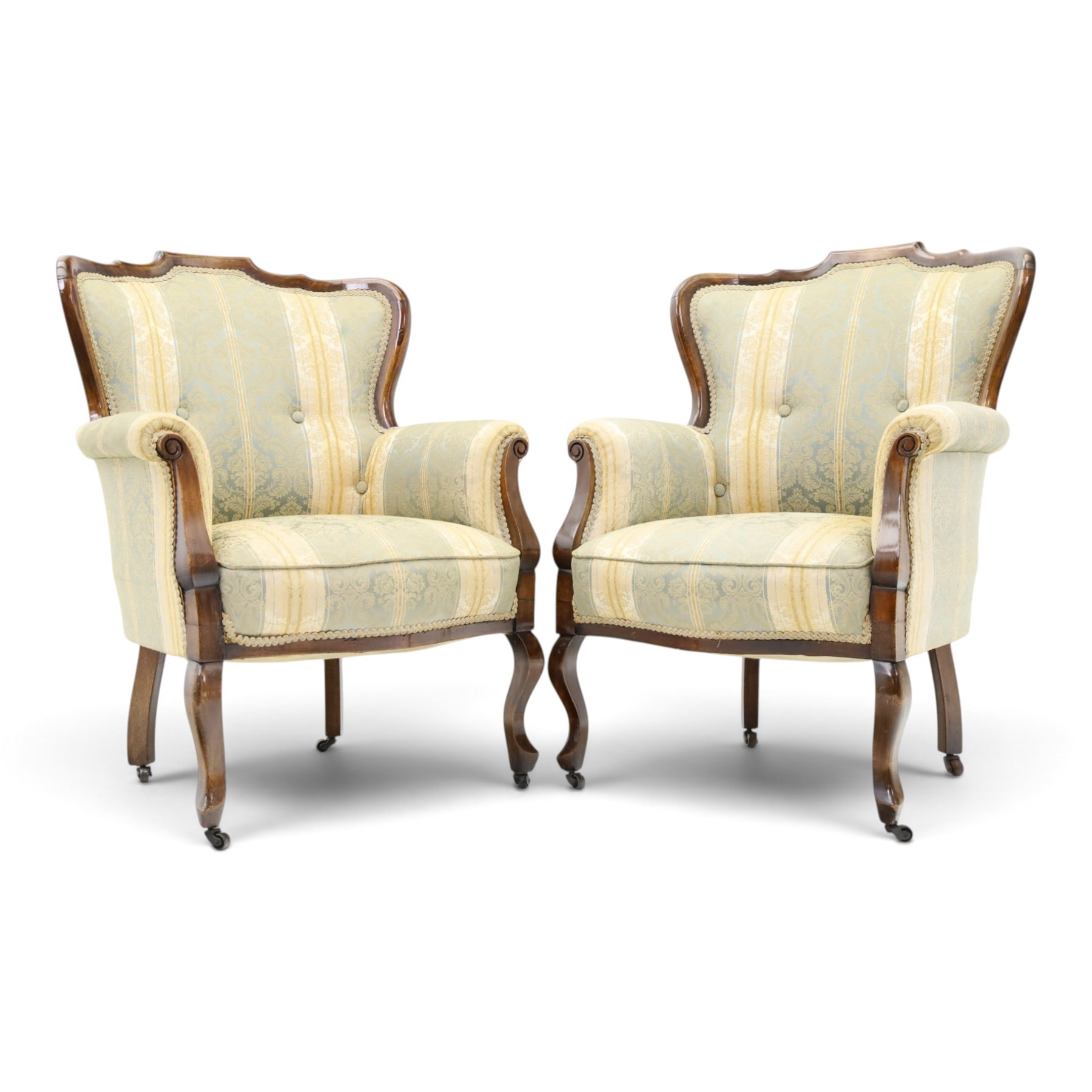 Edwardian mahogany three-piece salon suite, comprising settee and two armchairs, shaped frames with upholstered backs, scrolled arm supports and serpentine seat rails, upholstered in striped floral damask fabric, on cabriole supports with castors (Armchairs: H 96cm, W 70cm, D 68cm)