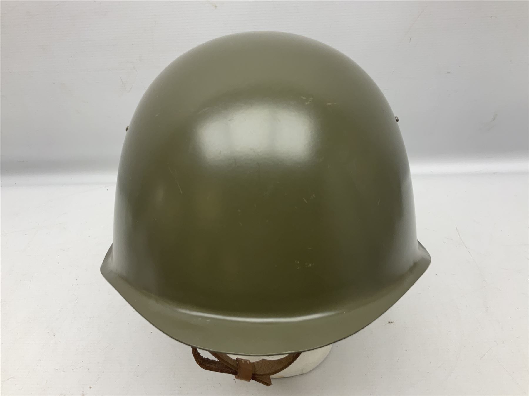 Two 1960s East Block Soviet style helmets - Czechoslovakian and Russian; both with liners (2)