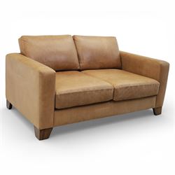 Modern two seat sofa in tanned leather, loose seat and base cushions, block arm rests abov...
