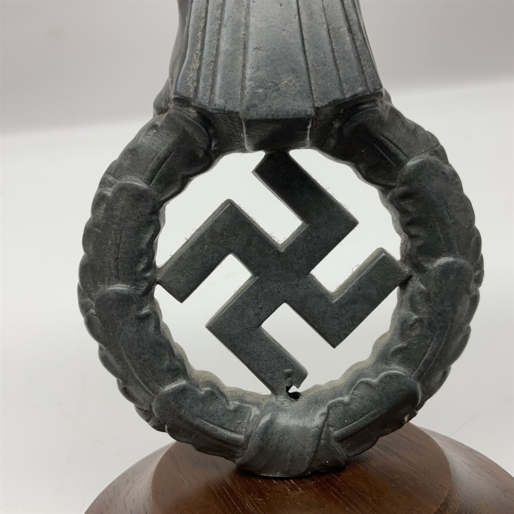WW2 German cast white metal desk ornament/paperweight as the eagle insignia on later turned mahogany plinth H22cm
