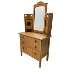 Early 20th century satin walnut dressing chest, fitted with raised mirror and two small cupboards with circular mirrors, rectangular top over three drawers, square supports with brass castors