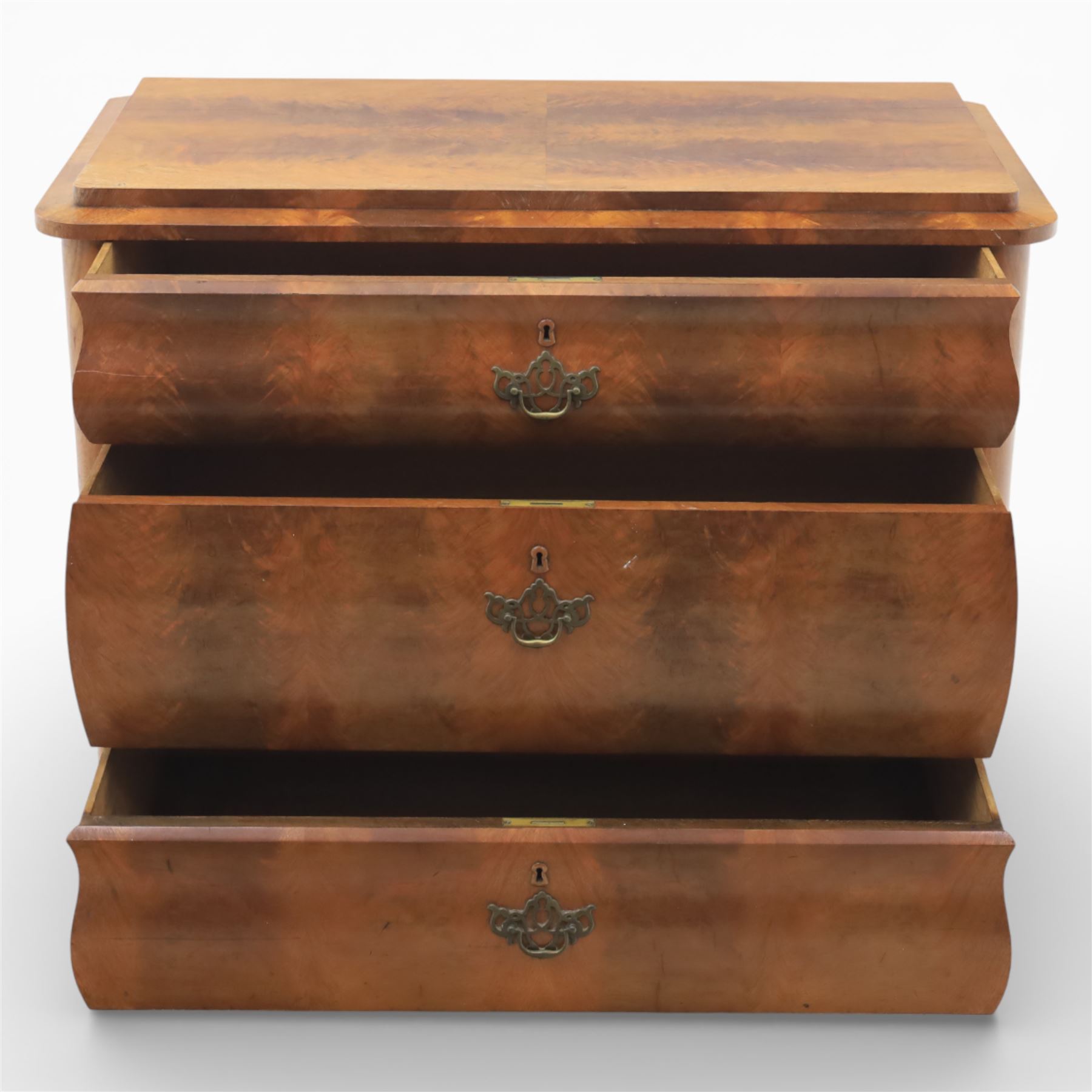 Late Victorian walnut and burr walnut chest of drawers, moulded top with rounded corners, finely figured burr walnut drawer fronts arranged as three long drawers, brass batwing handle plates, the lower section raised on turned bun feet