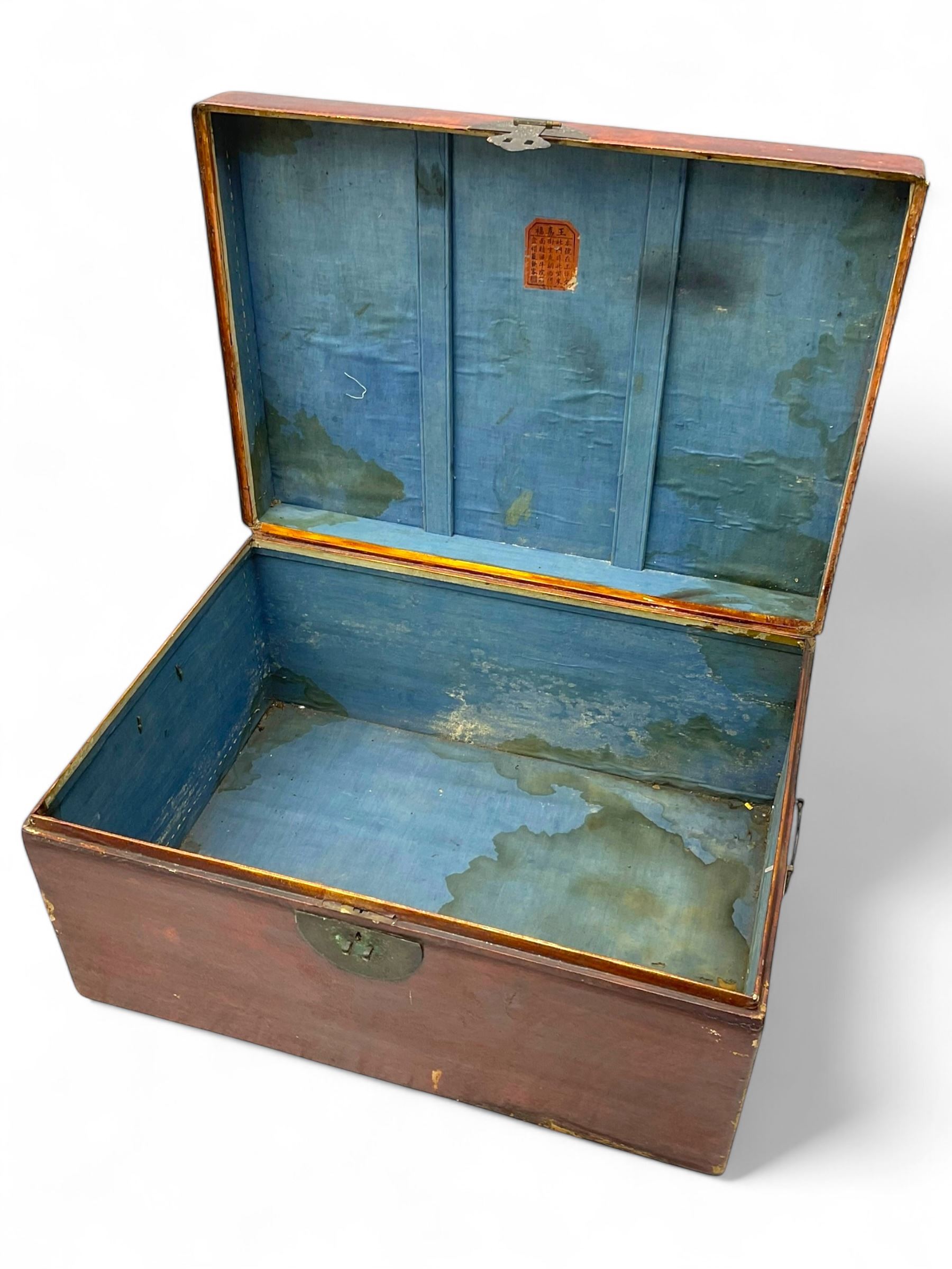 Pair of Chinese 18th century hand-painted leather-bound wooden trunks, each adorned with metal locks, twin carrying handles and patterned fabric-lined interior
