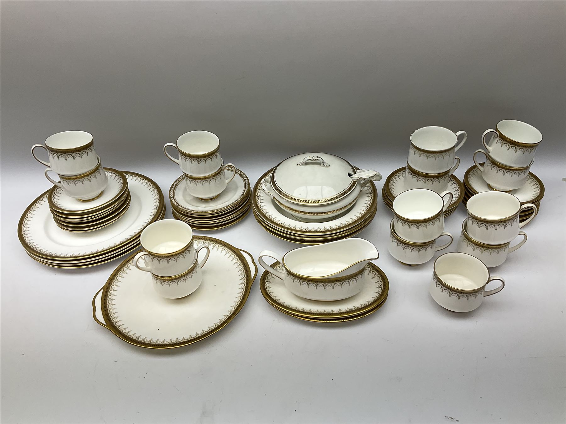 Paragon and Royal Albert tea and dinner wares in Athena pattern, including fifteen cups and saucers, gravy boat and saucer, four dinner plates, four soup bowls etc (52), together with three spode tea plates in golden bracelet pattern and another tureen with ladle in similar design. 