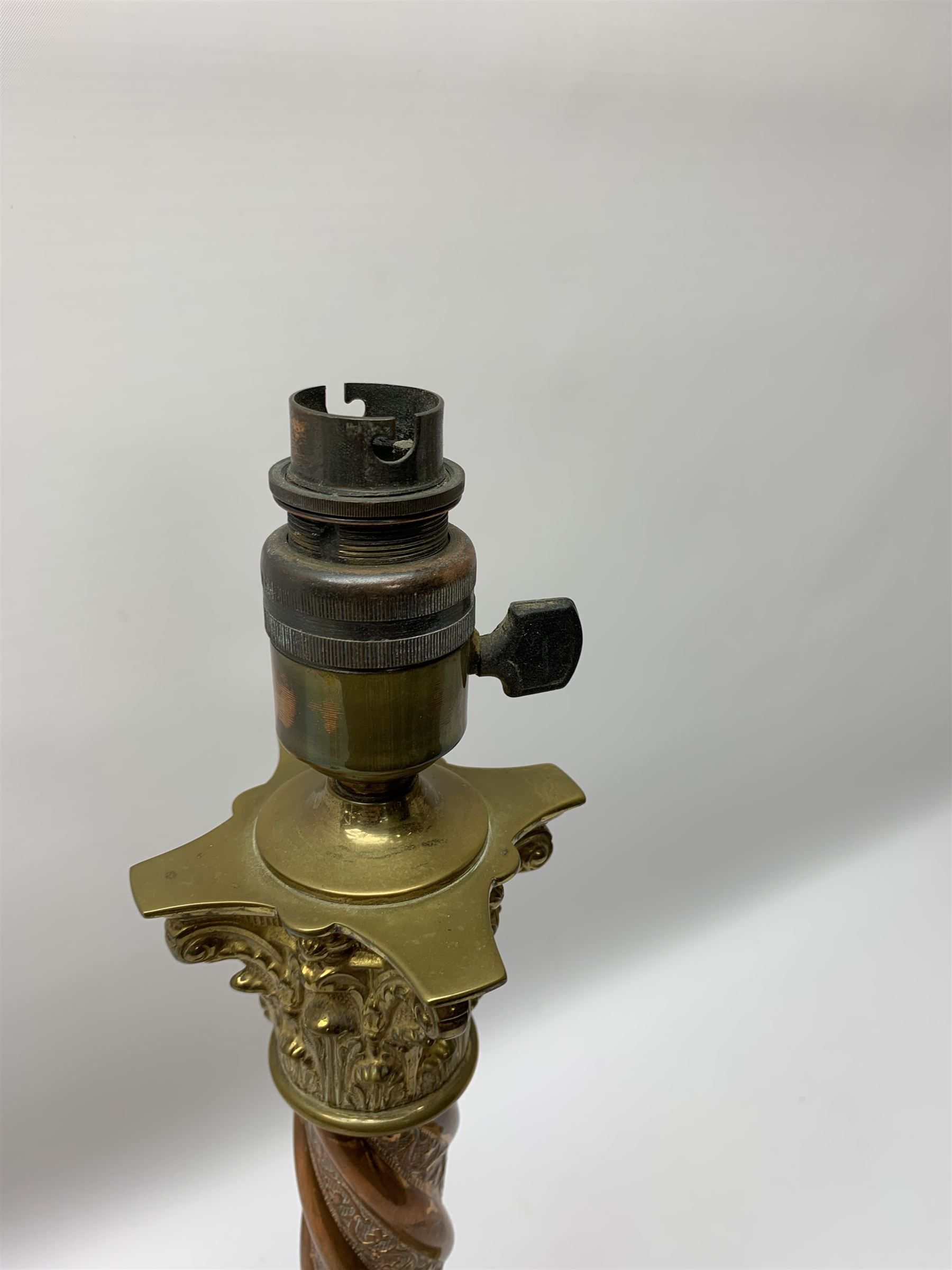 Early 20th century brass and copper Corinthian column table lamp, the square stepped brass base leading to a spiral twist copper column and brass Corinthian capital, H44.5cm 