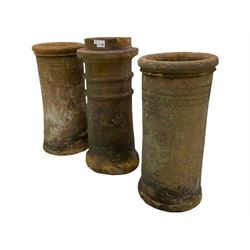 Three Victorian terracotta chimney pots with decorative banding 
