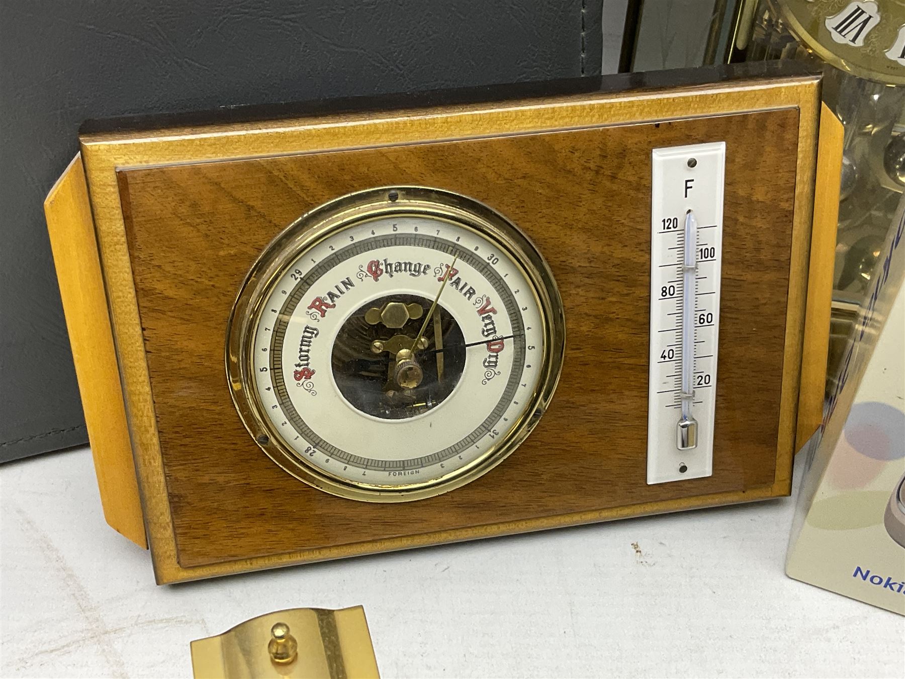 Kundo quartz clock, miniature brass clocks, two barometers, Sony digital camera, Nokia phone, Monarch Remington typewriter, commemorative Shilling etc