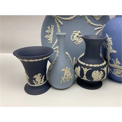 Large collection of Wedgwood Jasperware in dark blue, lilac and light blue, to include mantle clock, lidded boxes, vases, plates etc
