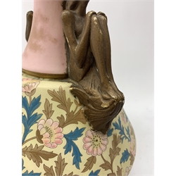 A late 19th century Aesthetic Movement Old Hall vase designed by Christopher Dresser, the flared body decorated with stylised flowering vines, leading to a tapering neck and flared rim with twin figural handles (one s/d), and raised upon a circular footed base, with printed mark beneath, H35cm. 