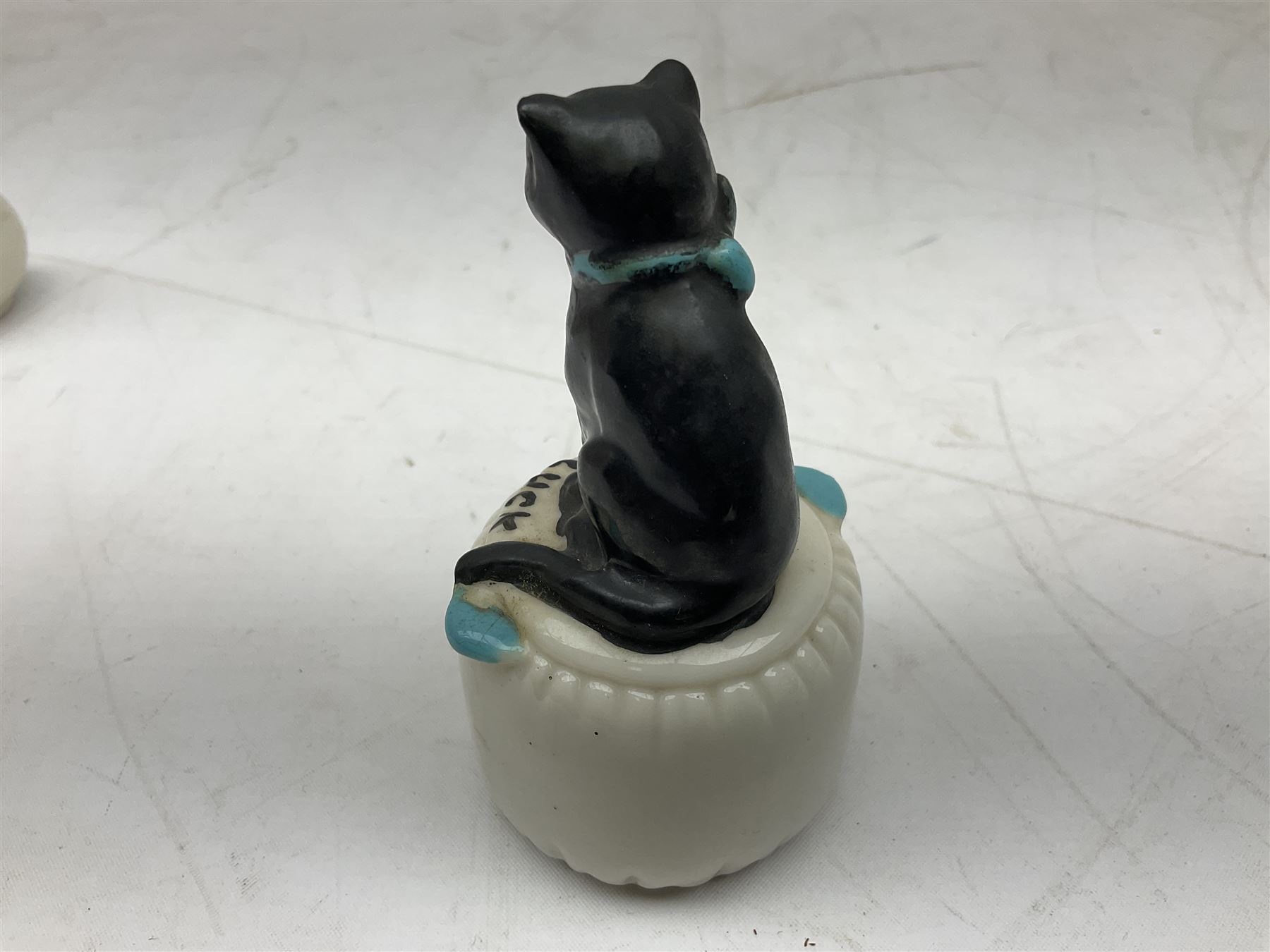 Five crested ware Good Luck black cats, comprising two Willow Art examples, two Arcadian examples and one Carlton China, to include Bridlington, Hull, Filey, etc, tallest H9cm