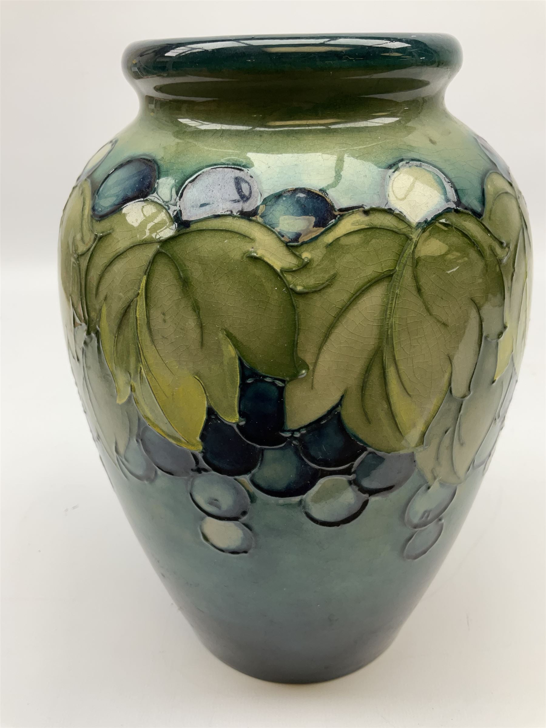 Moorcroft Grape and Leaf pattern baluster vase on green and blue ground, with impressed and painted mark beneath, H24cm