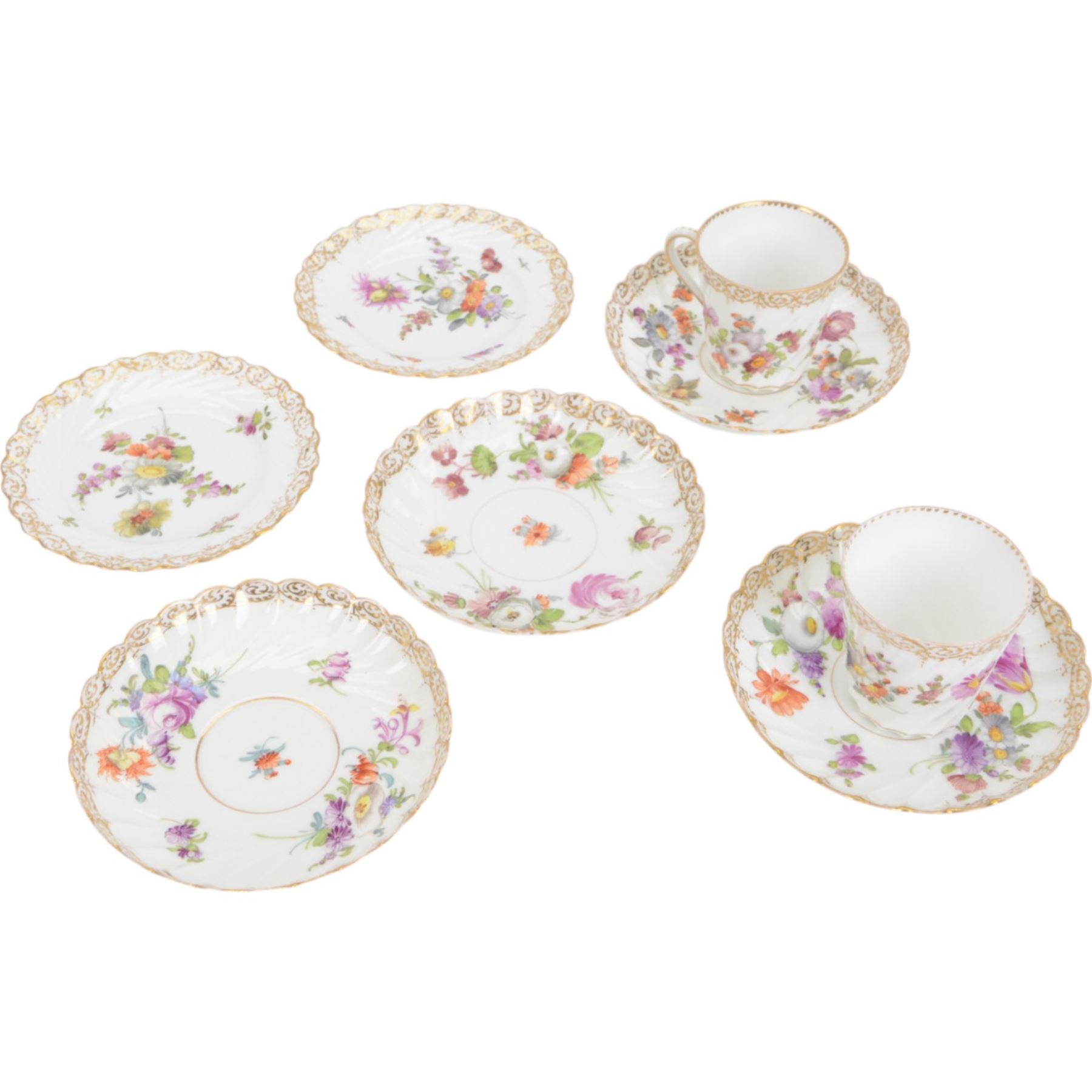 Two Dresden coffee cups and saucers, of fluted form decorated with flora spays together with two matching saucers and two dessert plates, cups H6cm  