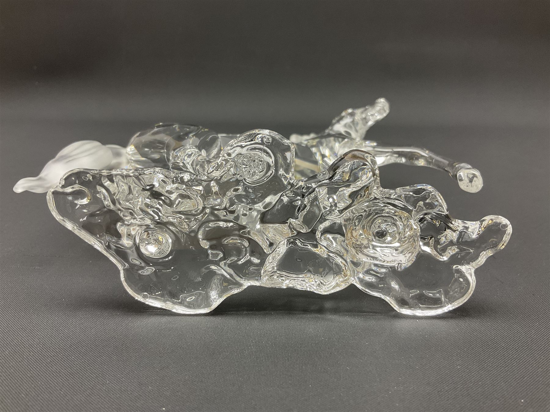 Five Swarovski Crystal horses, comprising stallion, rearing horse, pair of horses playing and Arabian stallion, each with frosted manes and tails, together with a small Swarovski Crystal galloping horse, the mane, tail and base with smoky tint
