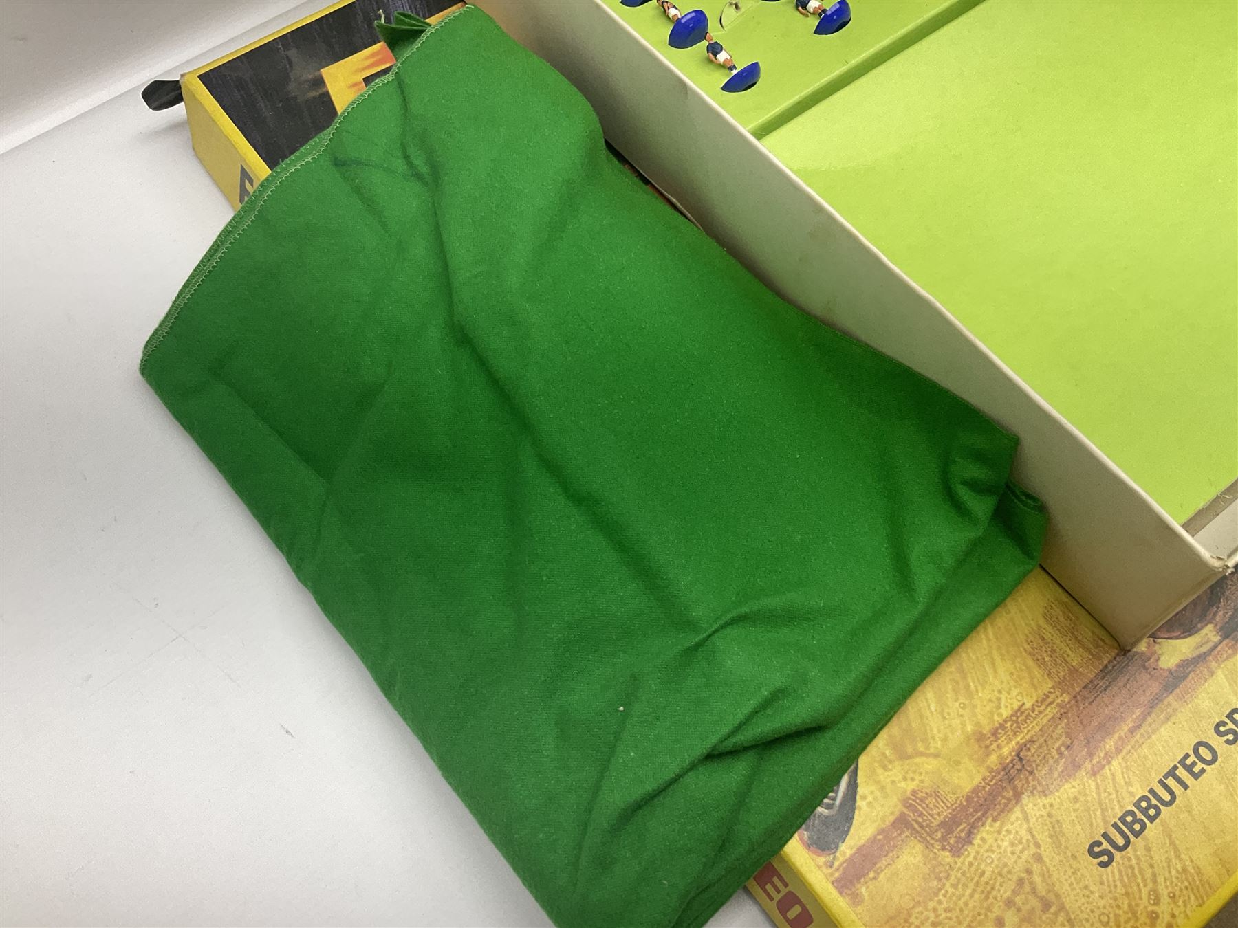 Subbuteo - three boxed sets comprising Football Express with two five-a-side teams and floodlighting; Continental with four teams and accessories; and International Edition Table Rugby with two teams; together with a Real Madrid 1974-75 League Champions pennant (4)