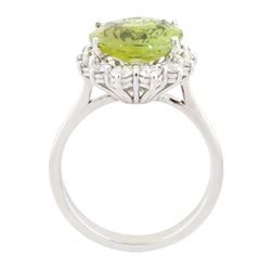 18ct white gold alexandrite and diamond cluster ring, the natural oval cut green alexandrite of approx 5.95 carat, surrounded by fourteen round brilliant cut diamonds, stamped 750, total diamond weight approx 0.80 carat