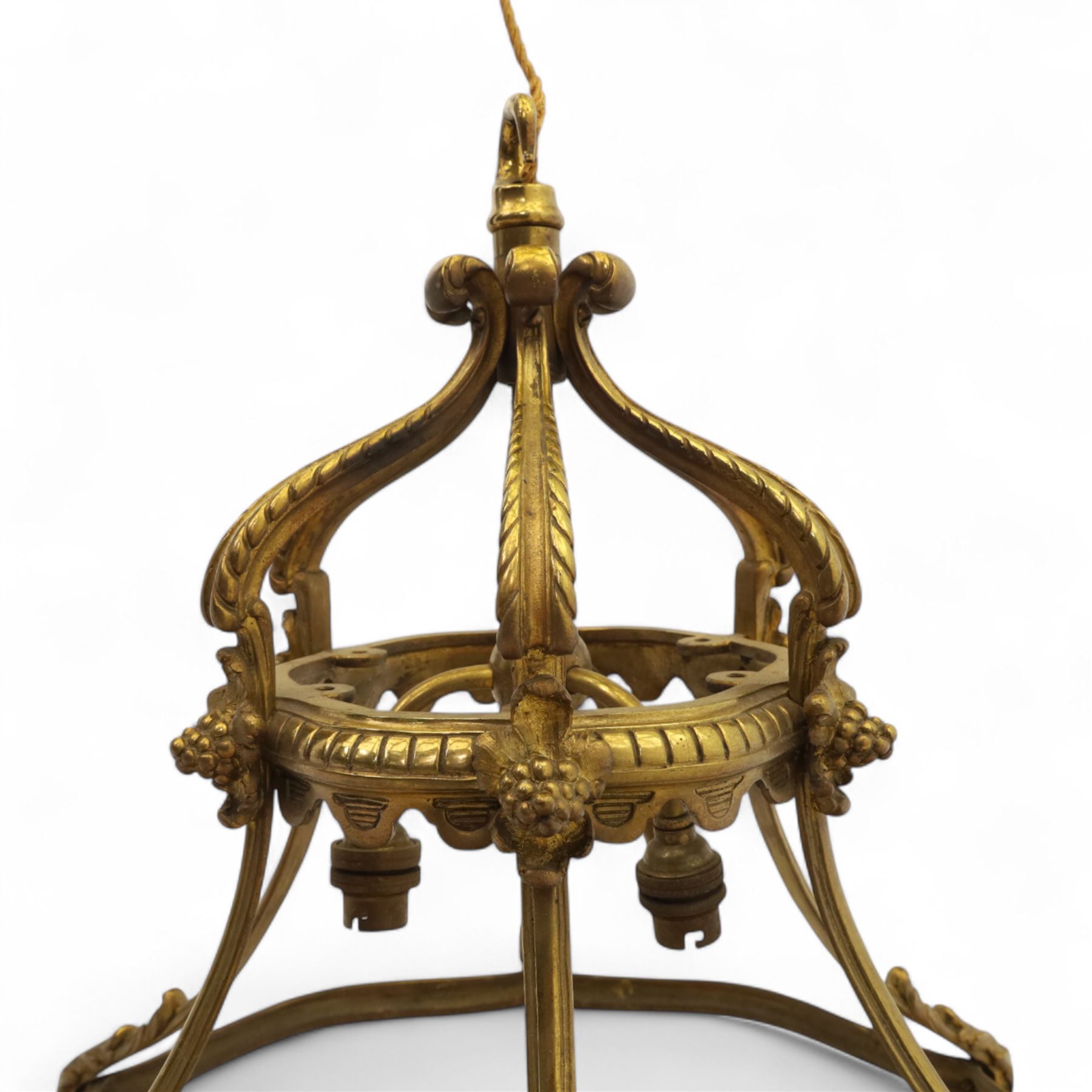 Late Victorian gilt bronze neoclassical style open chandelier, open crown form suspended chandelier with hook finial and downward sweeping reeded and scrolled arms forming a canopy with six acanthus decorated ribs, lower section outward curved ribs forming a circular hoop detailed with fluted ornament and small foliate clasps, wired for electricity 