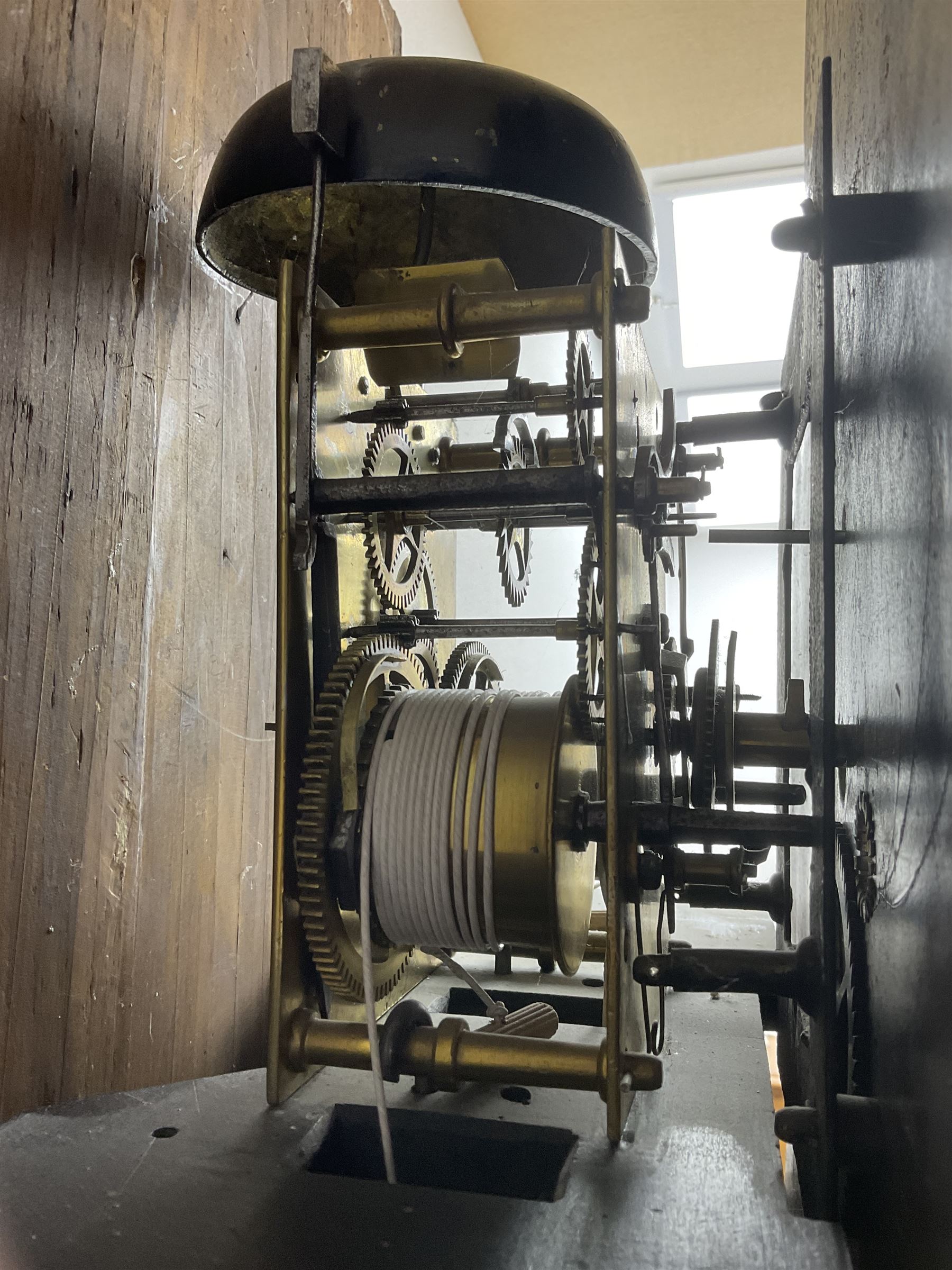Charles Fletcher of Barnsley - Oak and Mahogany 8-day longcase clock, c 1830, with a swans neck pediment, silk backed open fret work beneath and a break arch hood door, flanked by reeded pilasters with wooden capitals, trunk with reeded quarter columns and a break arch topped door, plinth with inlaid banding on a shaped base, painted dial with Arabic numerals, seconds and date dials, stamped brass hands and painted depictions of the four seasons to the spandrels, dial pinned via a false plate to a rack striking movement with a recoil anchor escapement, striking the hours on a cast bell. With weights and pendulum.