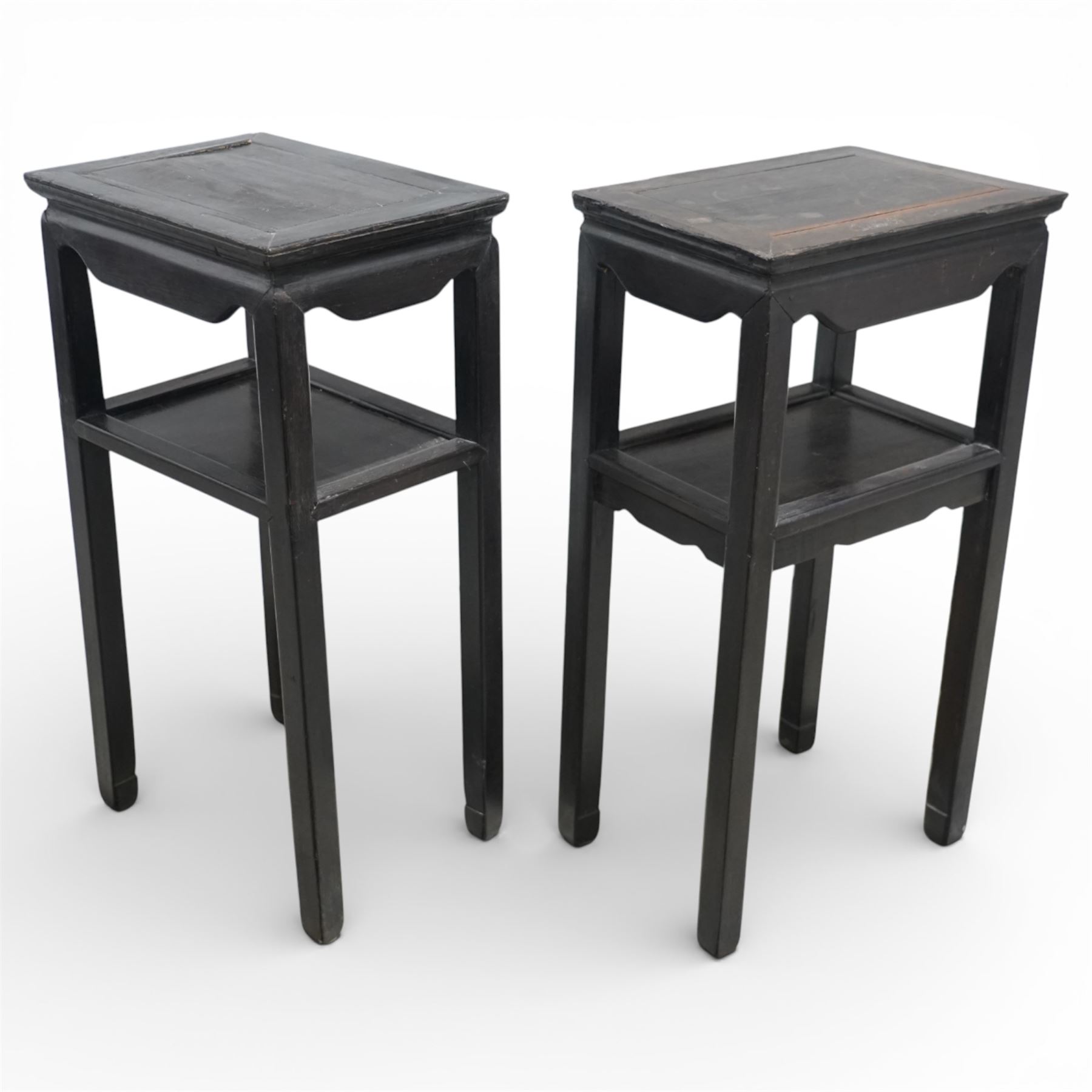 Near pair of 19th century Chinese hardwood stands, each with rectangular tops above plain friezes, open undershelves, square section legs joined by stretchers, black lacquered finish