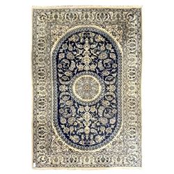 Persian Kashan ivory and indigo ground rug, traditional and intricate design around a cent...