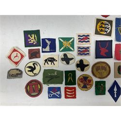 Approximately one-hundred printed and embroidered cloth badges including I, II, VIII, XI, XII and XXX Corps, Eastern Command, various Armoured Divisions, Midland, Wessex, Home Counties and 12th Infantry Brigades, Salisbury Plain, Northumberland, Hampshire, North Midland, West Riding, Essex and Suffolk Districts, Berlin & Rhine Army Troops etc