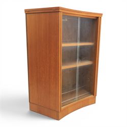 Turnidge of London - Mid 20th century teak drinks cabinet, shaped top with hinged fold-out side sections, twin doors with recessed handles enclosing fitted shelving and serving surfaces, sliding glass doors to the back, on a plinth base above castors