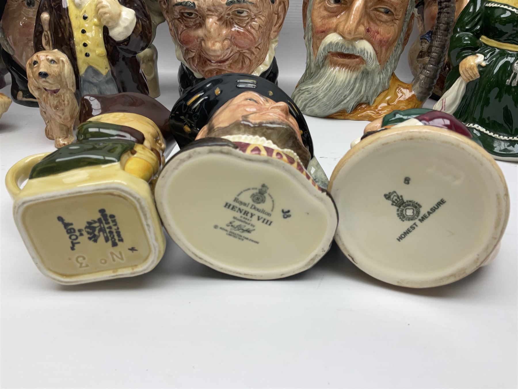Large collection of Royal Doulton character jugs, to include Robinson Crusoe D6532, Tam O Shanter D6632, The Falconer D6533 etc, together with similar charater jugs and toby jugs   